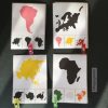 Montessori continent matching activity featuring colourful continent cards, black silhouettes, and mini clips. Activity example of printed, laminated cards are shown in the photograph. Cards are for geography learning and fine motor skill practice, perfect for Montessori classrooms and homeschooling.