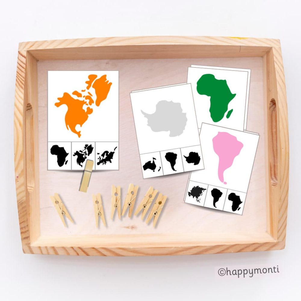 Montessori continent silhouette matching cards with colourful continent designs, black silhouettes, and wooden clothespins in a tray. Perfect for geography education and fine motor development in Montessori and homeschool settings.