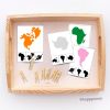 Montessori continent silhouette matching cards with colourful continent designs, black silhouettes, and wooden clothespins in a tray. Perfect for geography education and fine motor development in Montessori and homeschool settings.