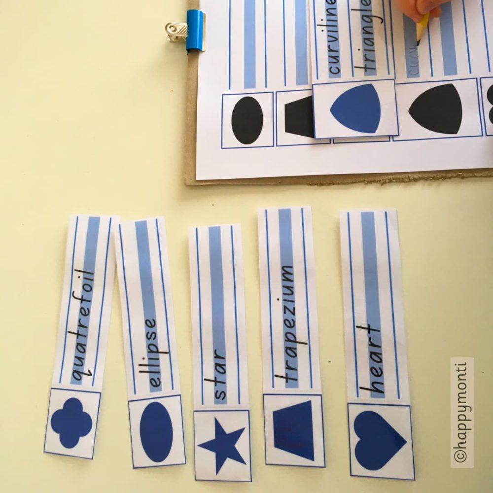 Montessori metal inset shapes handwriting activity with shape word cards – child practicing shape names like ellipse, trapezium, and curvilinear triangle to build fine motor skills and early literacy through hands-on learning.