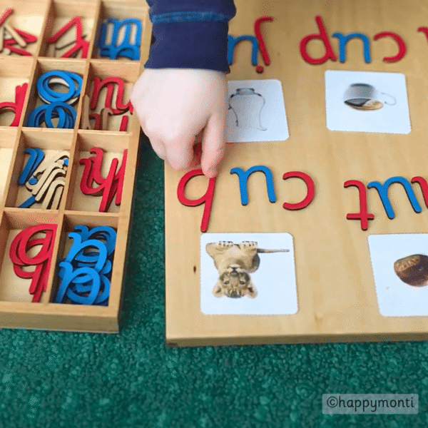 Child using Montessori Movable Alphabet activity spelling CVC words “cub”, "nut", "cup" and "jug" with photo cards, supporting early literacy, phonics, and spelling practice in a Montessori-inspired learning setup.